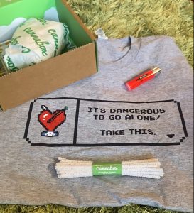 Cannabox t-shirt under a red Cannabox lighter with pixel sword and white Cannabox pipe cleaners