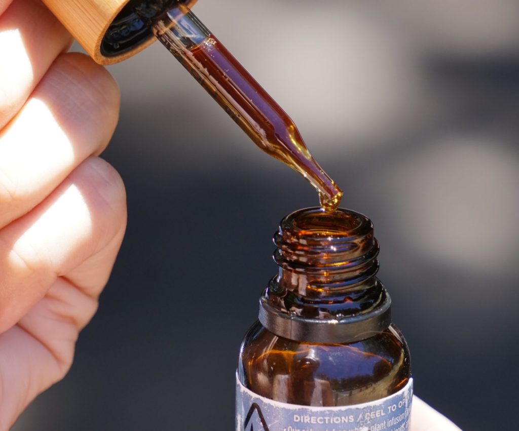 brown cannabis oil in a glass dropper