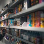 woman in black shirt standing in front of store shelf