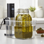 A jar filled with ground cannabis and oil sitting in a water bath